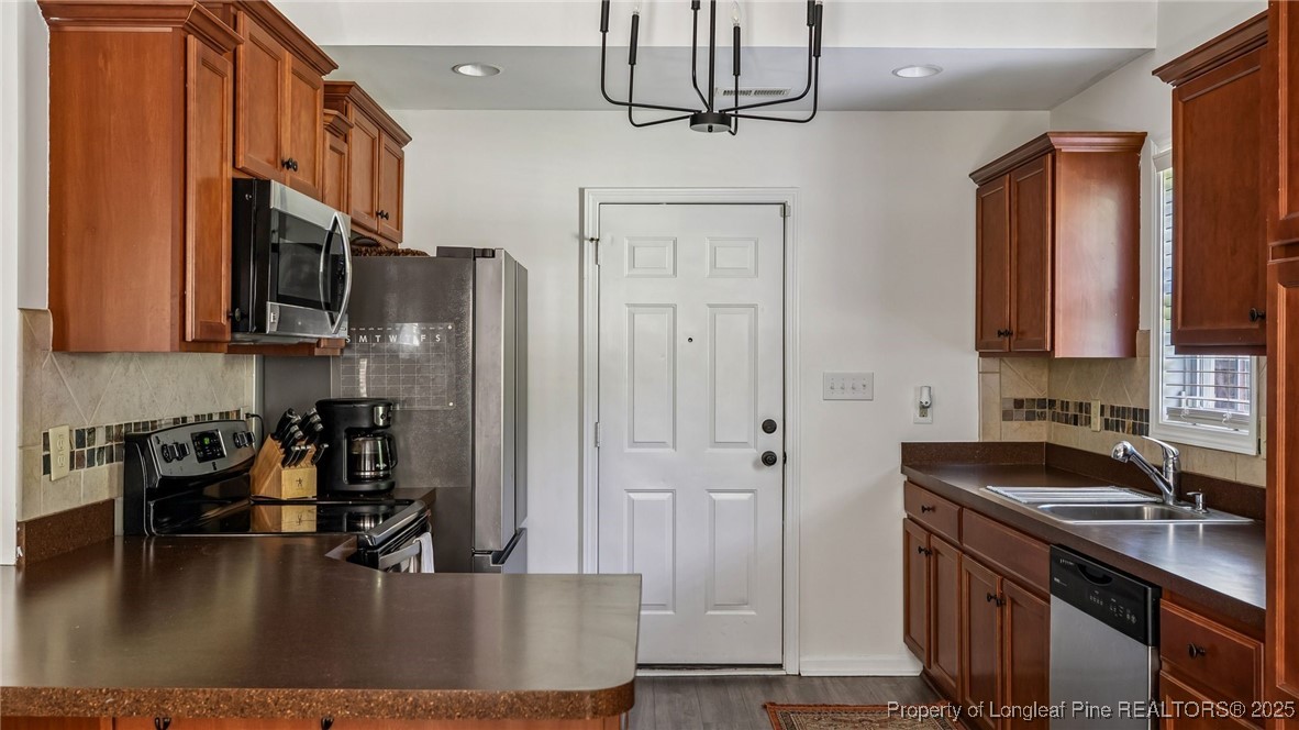 230 Michael Drive Raeford, NC 28376 - Photo 13 of 43 a kitchen with stainless steel appliances granite countertop a sink a stove and a refrigerator
