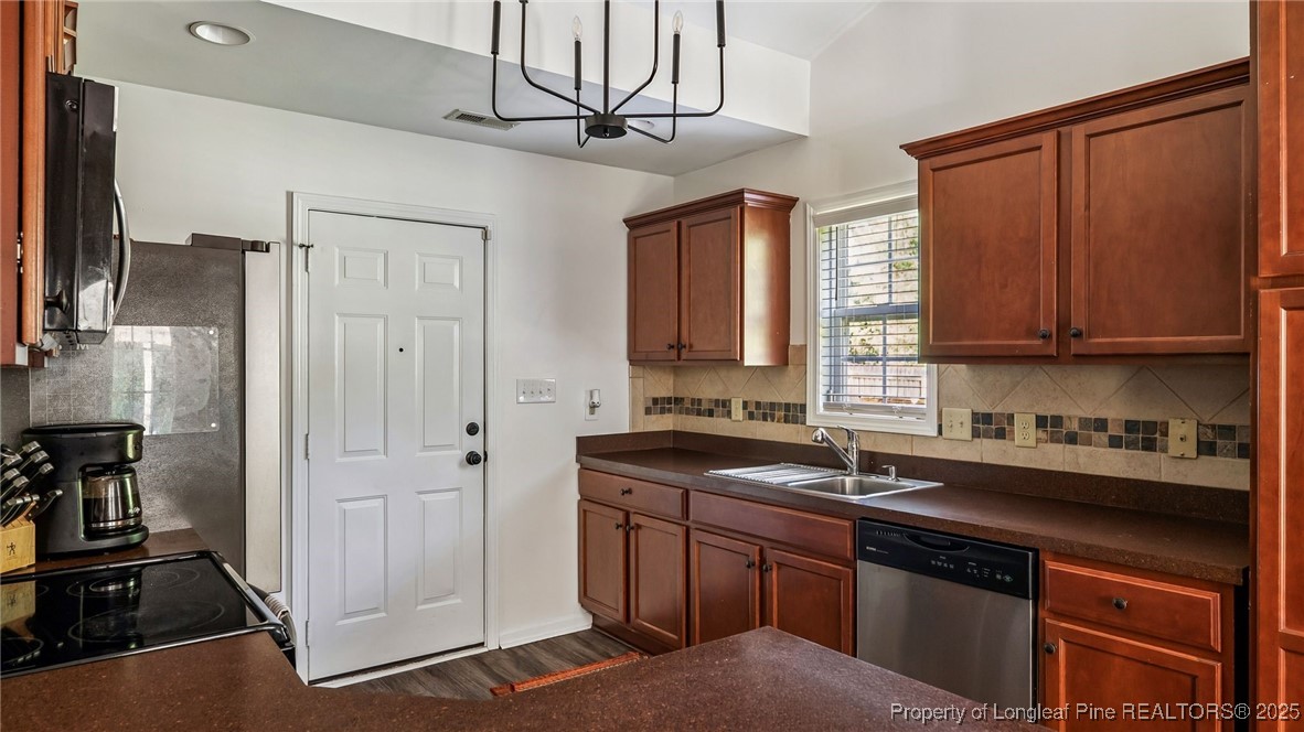 230 Michael Drive Raeford, NC 28376 - Photo 14 of 43 a kitchen with stainless steel appliances granite countertop a sink a stove and a refrigerator