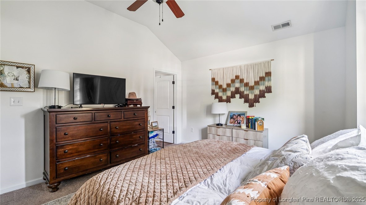 230 Michael Drive Raeford, NC 28376 - Photo 19 of 43 a bedroom with a bed and a flat tv screen on dresser