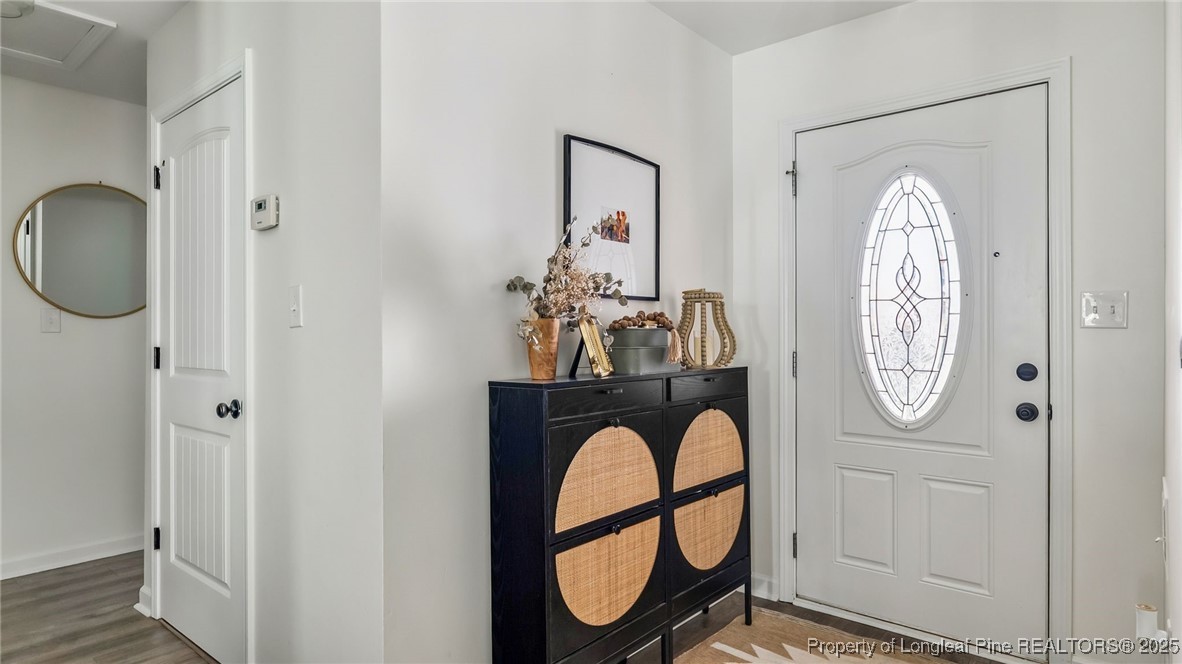 230 Michael Drive Raeford, NC 28376 - Photo 3 of 43 a front view of a house with entryway wooden floor and a chandelier