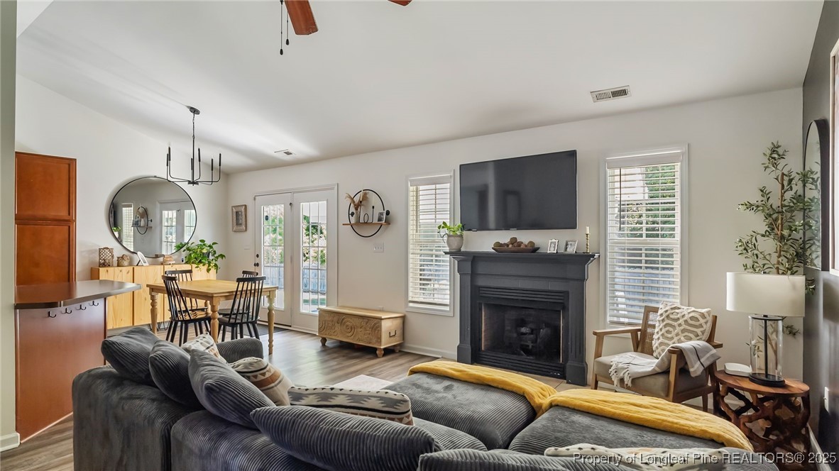 230 Michael Drive Raeford, NC 28376 - Photo 4 of 43 a living room with furniture a flat screen tv and a fireplace