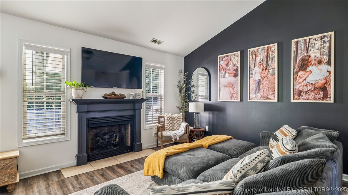 230 Michael Drive Raeford, NC 28376 - Photo 5 of 43 a living room with furniture a flat screen tv and a fireplace
