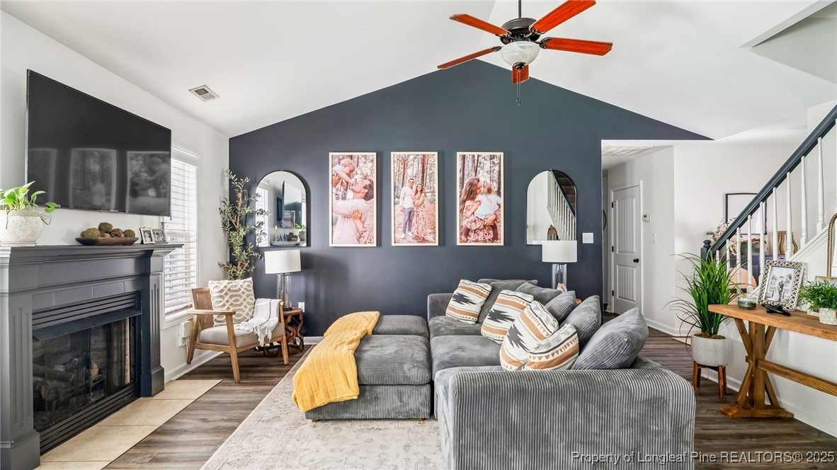 230 Michael Drive Raeford, NC 28376 - Photo 9 of 43 a living room with furniture a flat screen tv and a fireplace