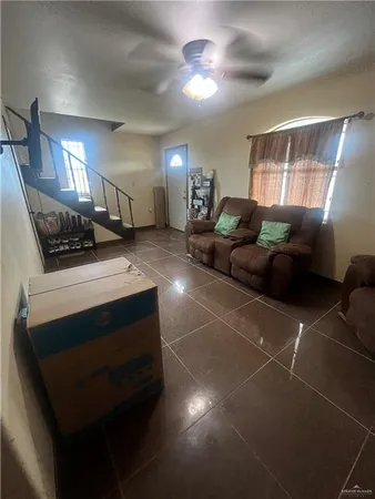 a living room with furniture and a chandelier