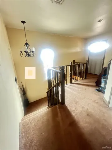 a view of a livingroom with furniture and stairs