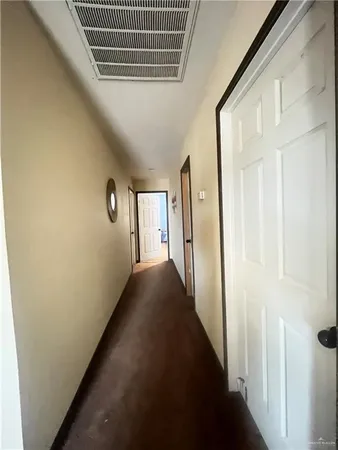 a view of a hallway with a white door