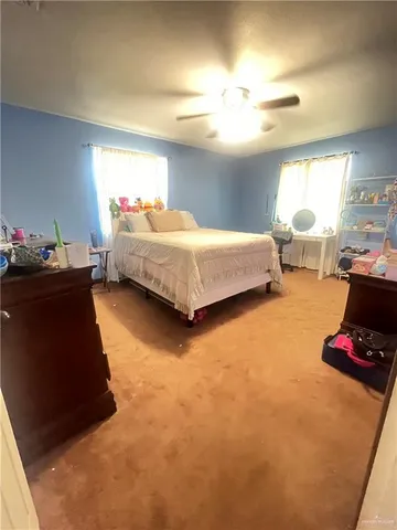 a bedroom with a bed and window