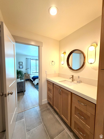 3626 Riverstone Road Mapleton, UT 84664 - Photo 31 of 58 Bathroom featuring vanity, ensuite bathroom, and dark tile patterned flooring