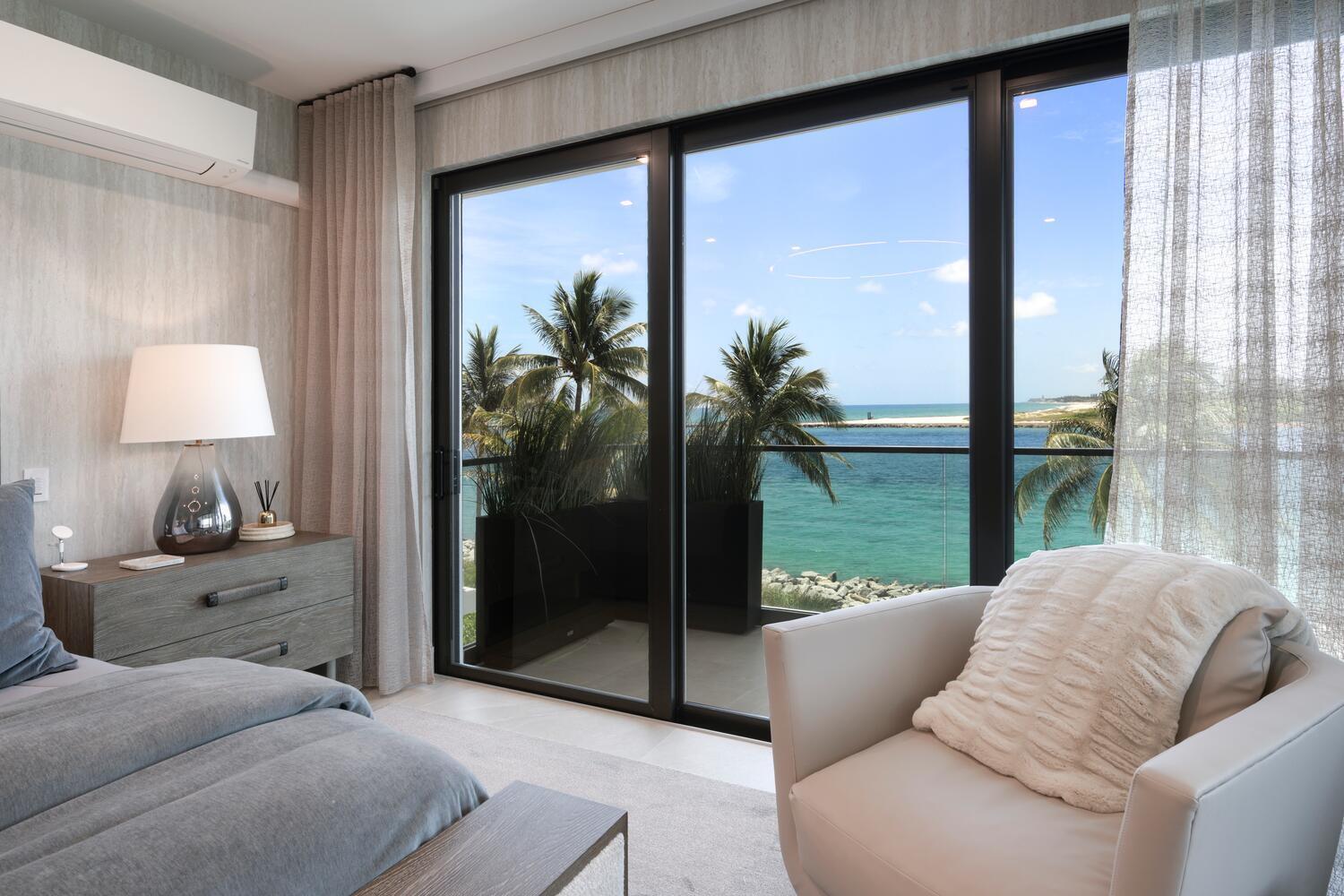 206 Inlet Way, Unit 2W Palm Beach Shores, FL 33404 - Photo 11 of 53 a living room with couch and a floor to ceiling window