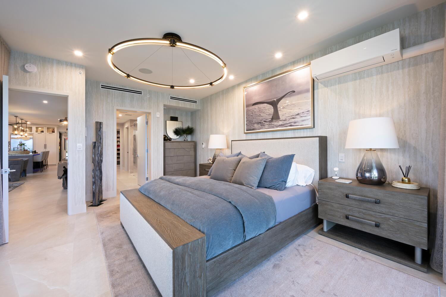 206 Inlet Way, Unit 2W Palm Beach Shores, FL 33404 - Photo 12 of 53 a spacious bedroom with a bed and a lamp