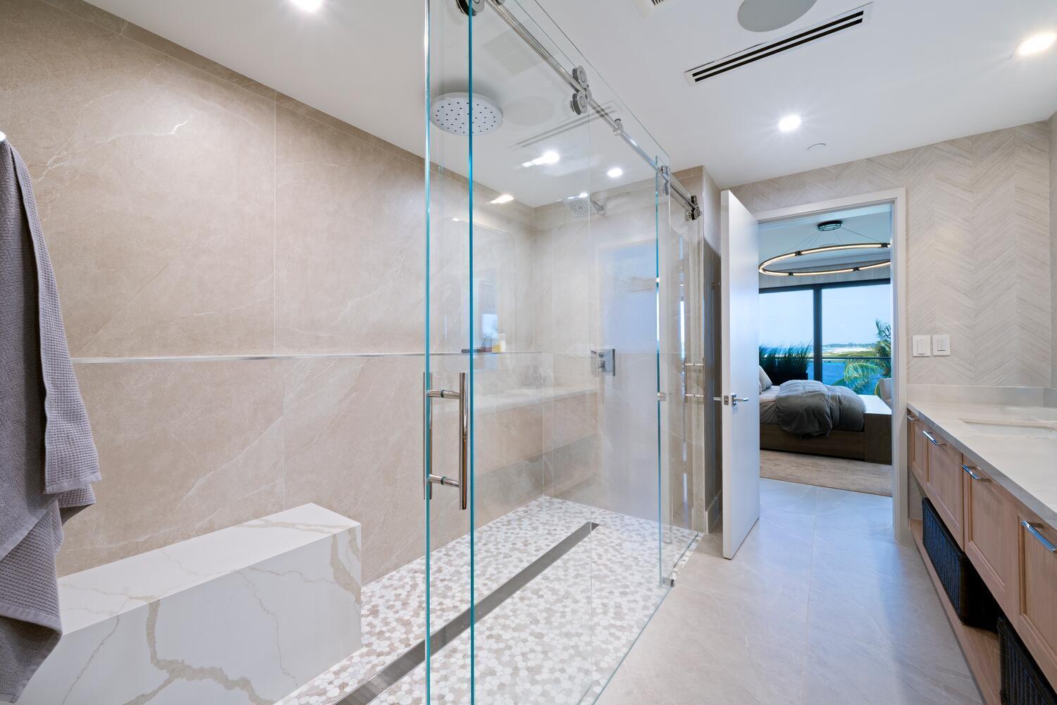 206 Inlet Way, Unit 2W Palm Beach Shores, FL 33404 - Photo 14 of 53 a en suite bathroom with a glass shower door and a sink