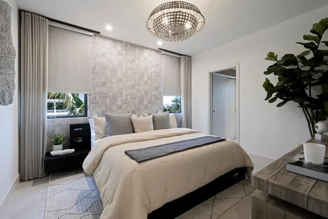 a bedroom with a bed and a chandelier