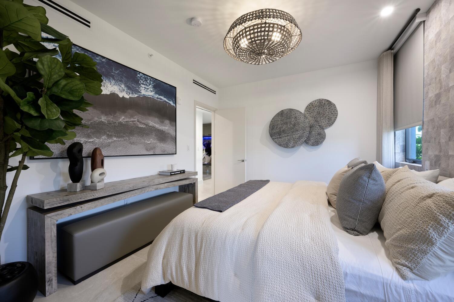 206 Inlet Way, Unit 2W Palm Beach Shores, FL 33404 - Photo 17 of 53 a bedroom with a bed and a potted plant on the dresser