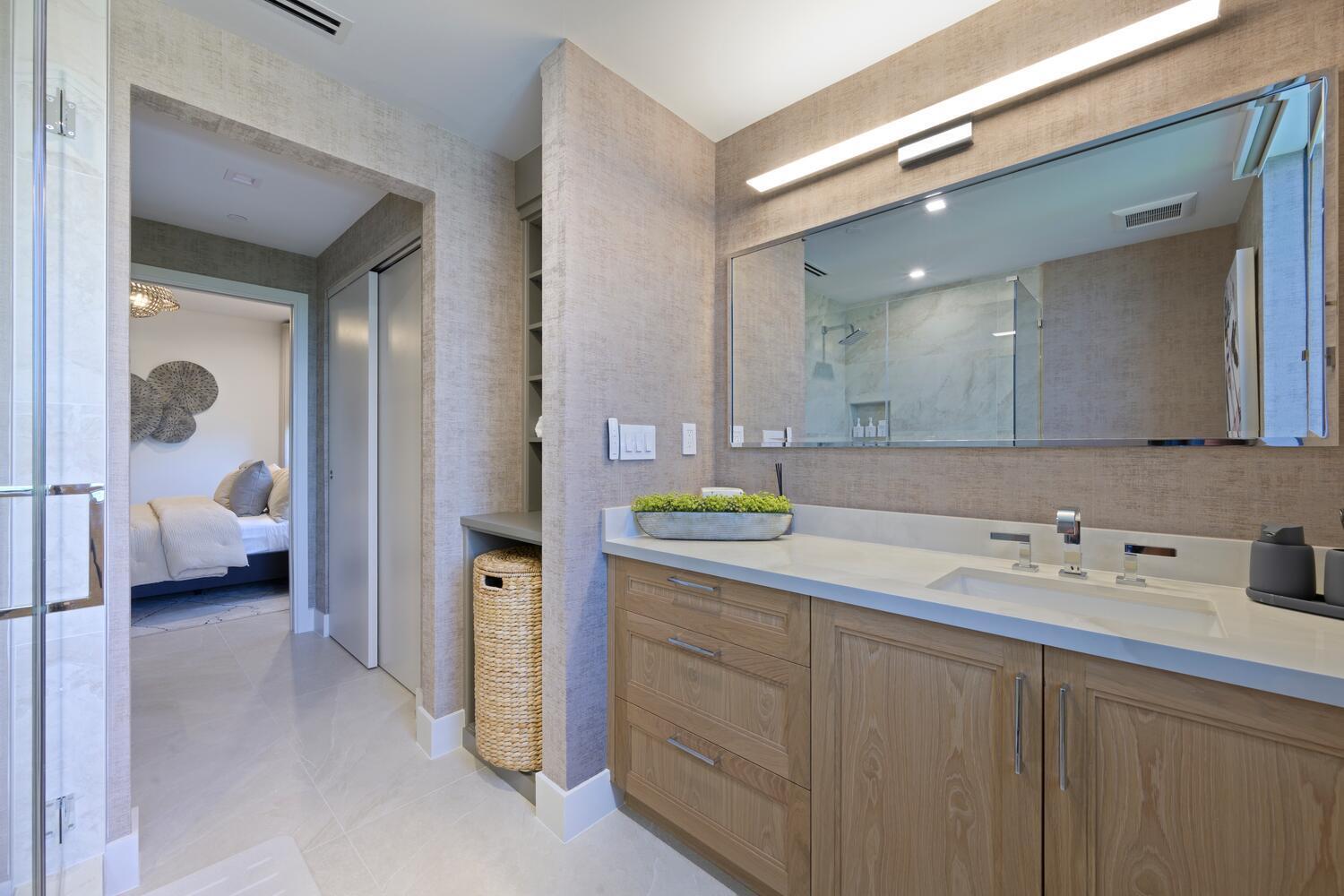 206 Inlet Way, Unit 2W Palm Beach Shores, FL 33404 - Photo 18 of 53 a en suite bathroom with a sink and mirror