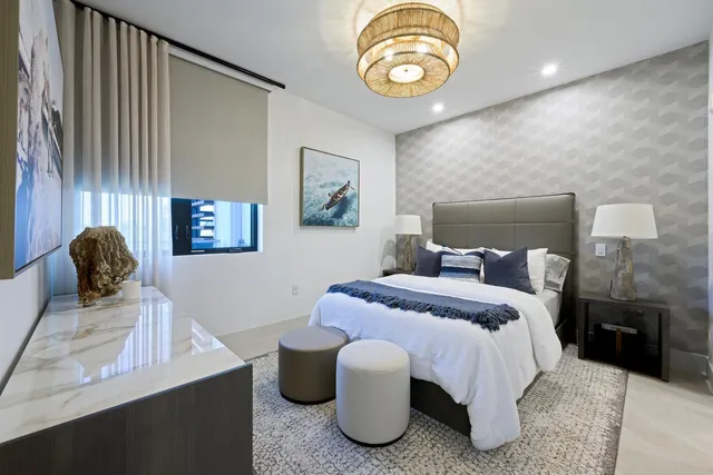 a bedroom with a bed and a chandelier