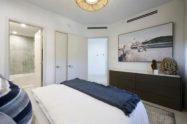 a bedroom with a bed and a painting on the wall