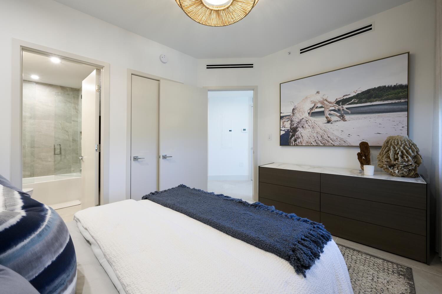 206 Inlet Way, Unit 2W Palm Beach Shores, FL 33404 - Photo 21 of 53 a bedroom with a bed and a painting on the wall