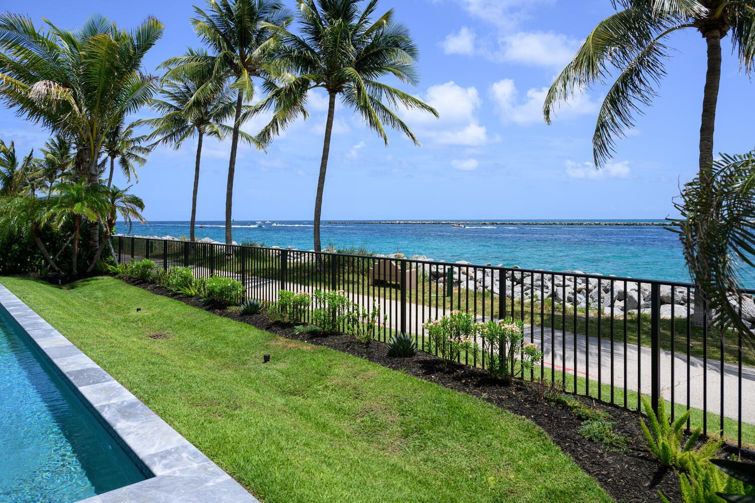 206 Inlet Way, Unit 2W Palm Beach Shores, FL 33404 - Photo 32 of 53 a view of a garden and palm trees