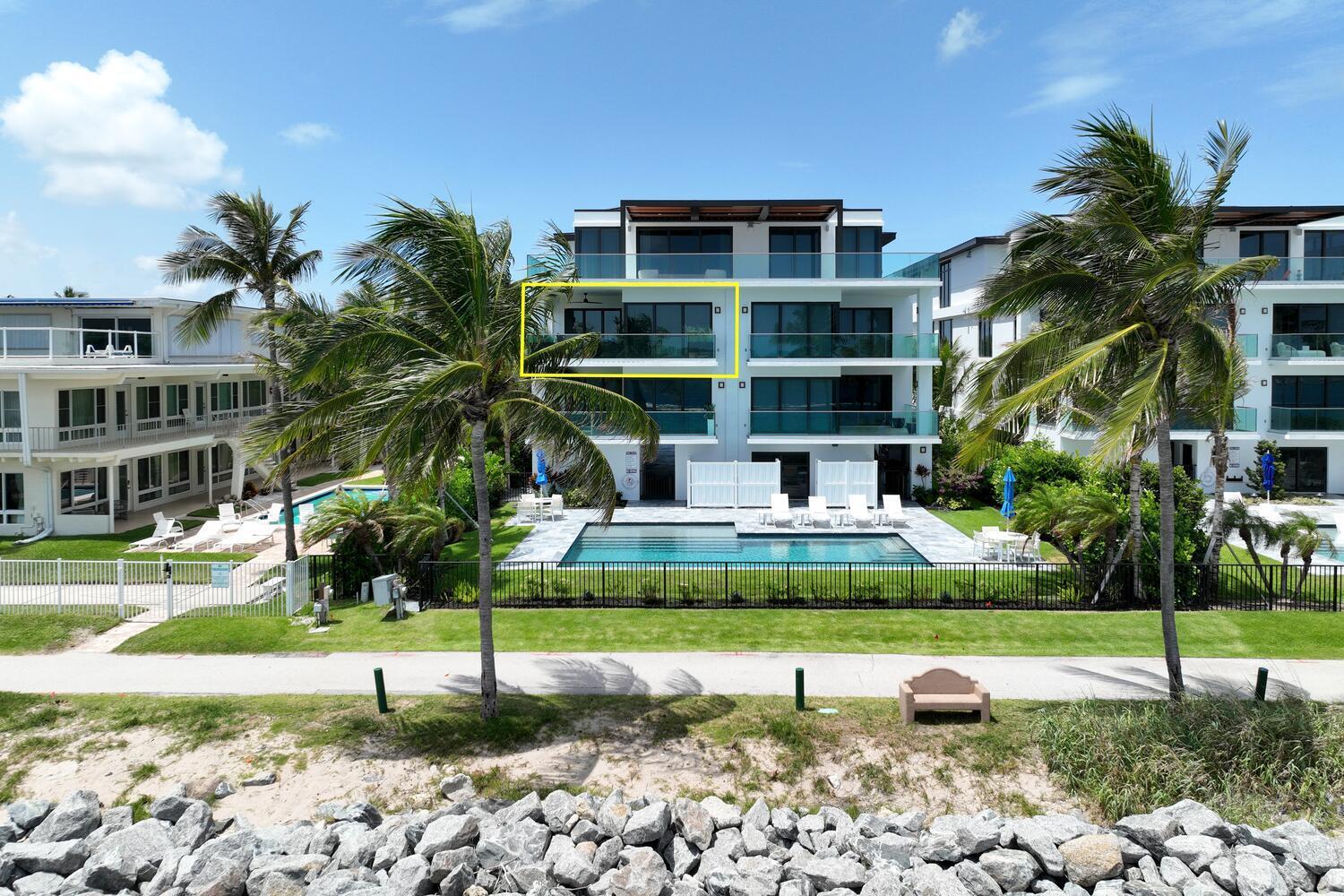 206 Inlet Way, Unit 2W Palm Beach Shores, FL 33404 - Photo 33 of 53 a front view of a house with a yard