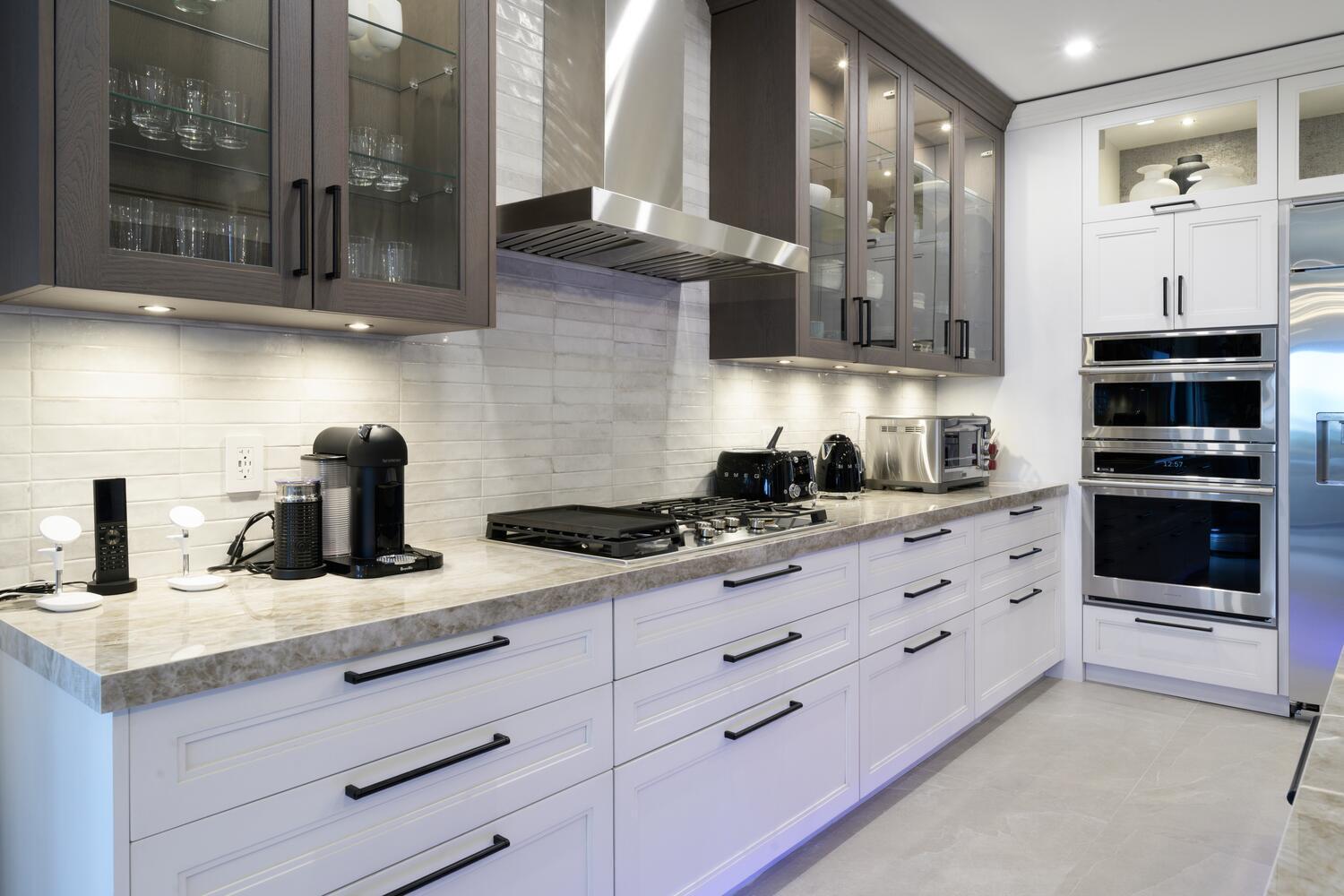 206 Inlet Way, Unit 2W Palm Beach Shores, FL 33404 - Photo 7 of 53 a kitchen with granite countertop a sink and cabinets