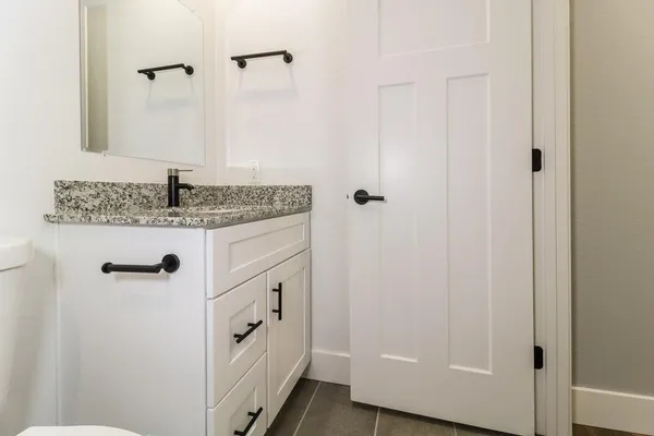 a bathroom with a granite countertop sink