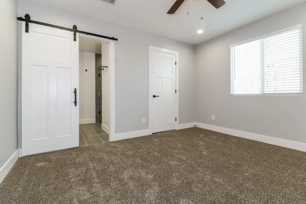 3865 West Gaby Road Phoenix, AZ 85041 - Photo 9 of 16 a view of an empty room with a window