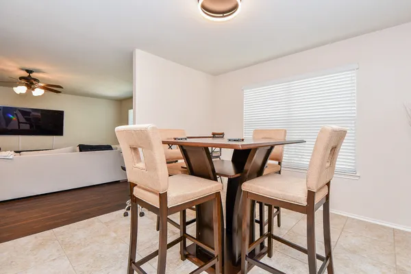 a view of a dining room with furniture and wooden floor