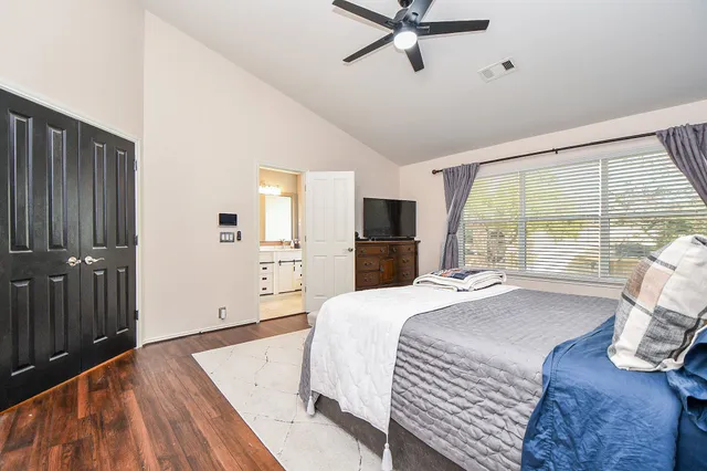 a bedroom with a bed and a large window