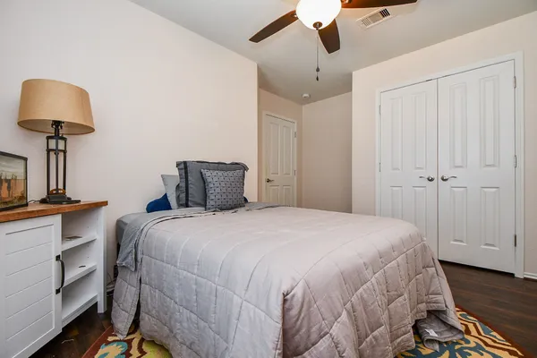 a bedroom with a bed and a lamp