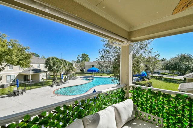 a view of a house with a yard and porch