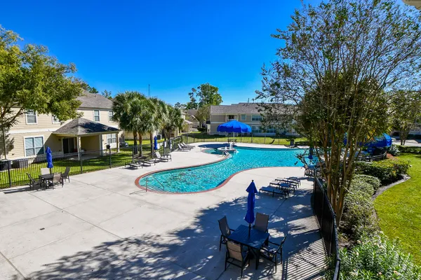 a swimming pool with outdoor seating and yard
