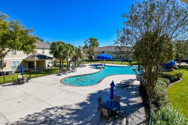 a swimming pool with outdoor seating and yard