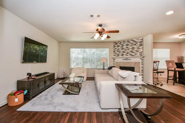 a living room with furniture fireplace and flat screen tv