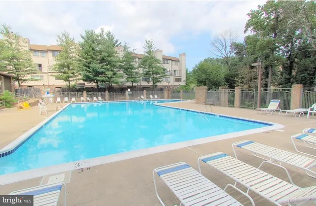 a view of a swimming pool with an outdoor space and seating area