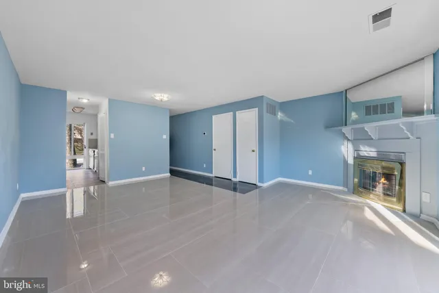 a view of an empty room with a fireplace