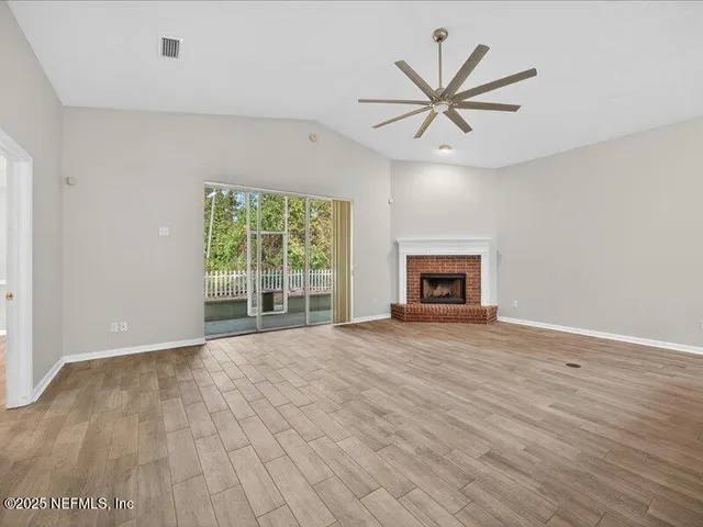 a view of a kitchen with a sink and a fireplace
