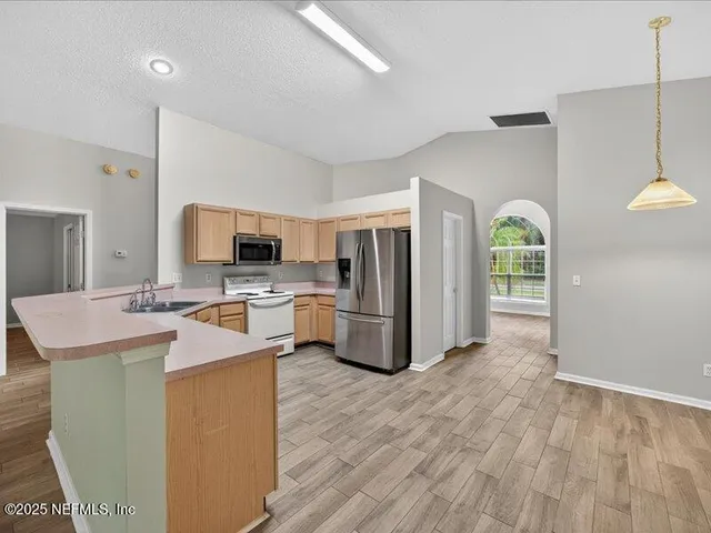 a kitchen with a sink stove and refrigerator