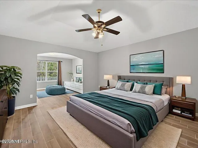 a view of an empty room with window and wooden floor