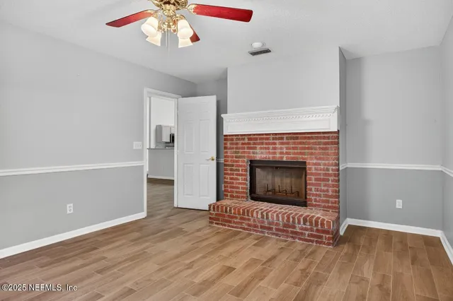 a spacious bedroom with a bed and a flat screen tv