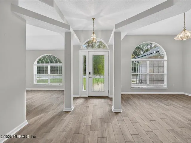 a living room with furniture a rug and a large window