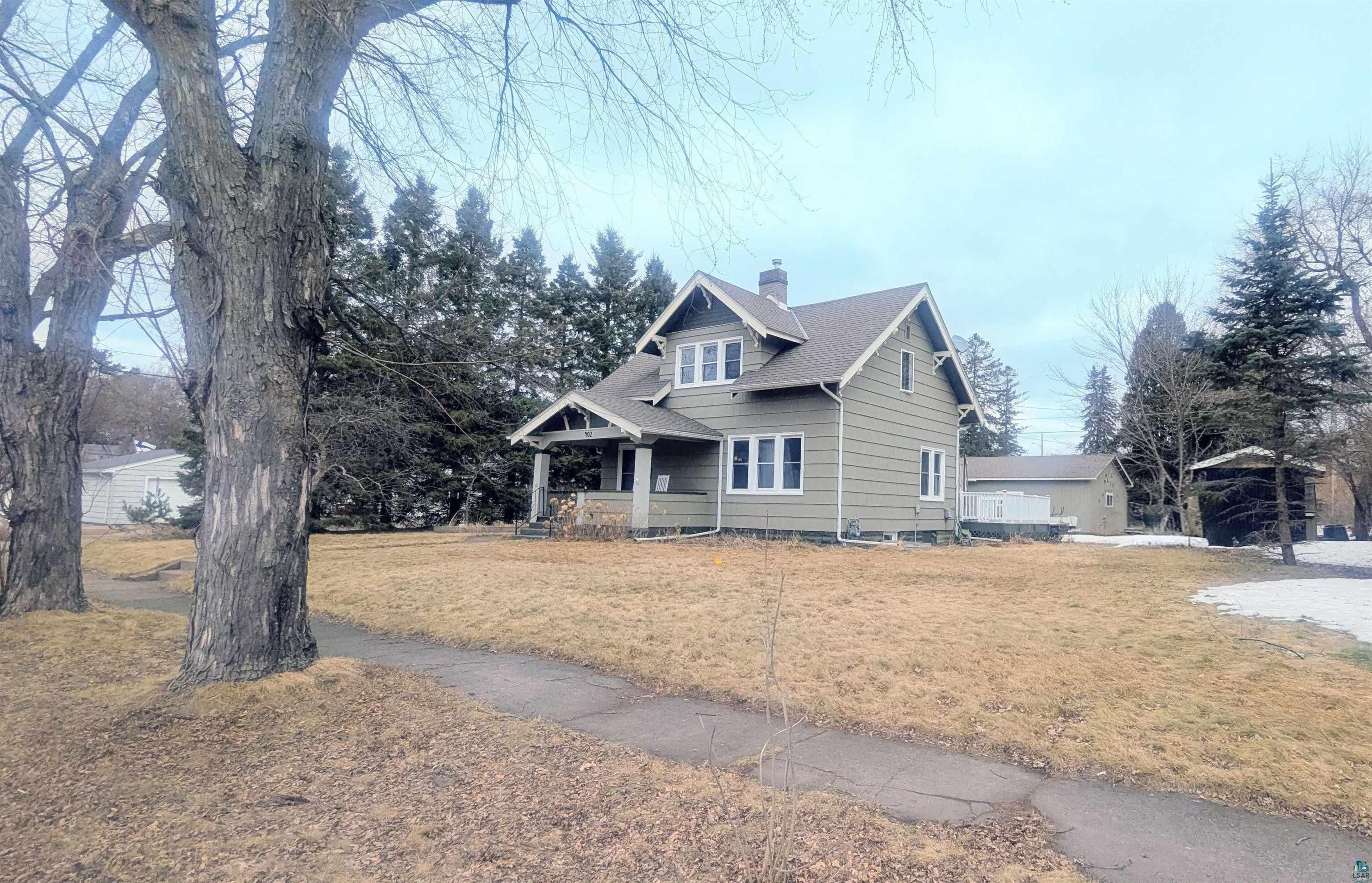 402 3rd Street Cloquet, MN 55720 - Photo 2 of 5 View of front of property with a chimney, a front lawn, and covered porch