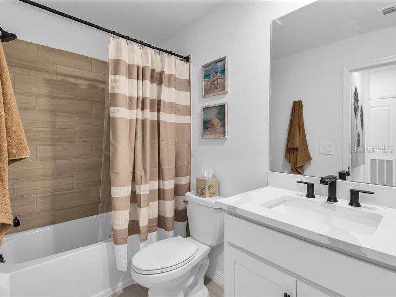 19116 Scallop Loop, Unit 303 Lakewood Ranch, FL 34211 - Photo 25 of 32 a bathroom with a sink toilet and shower
