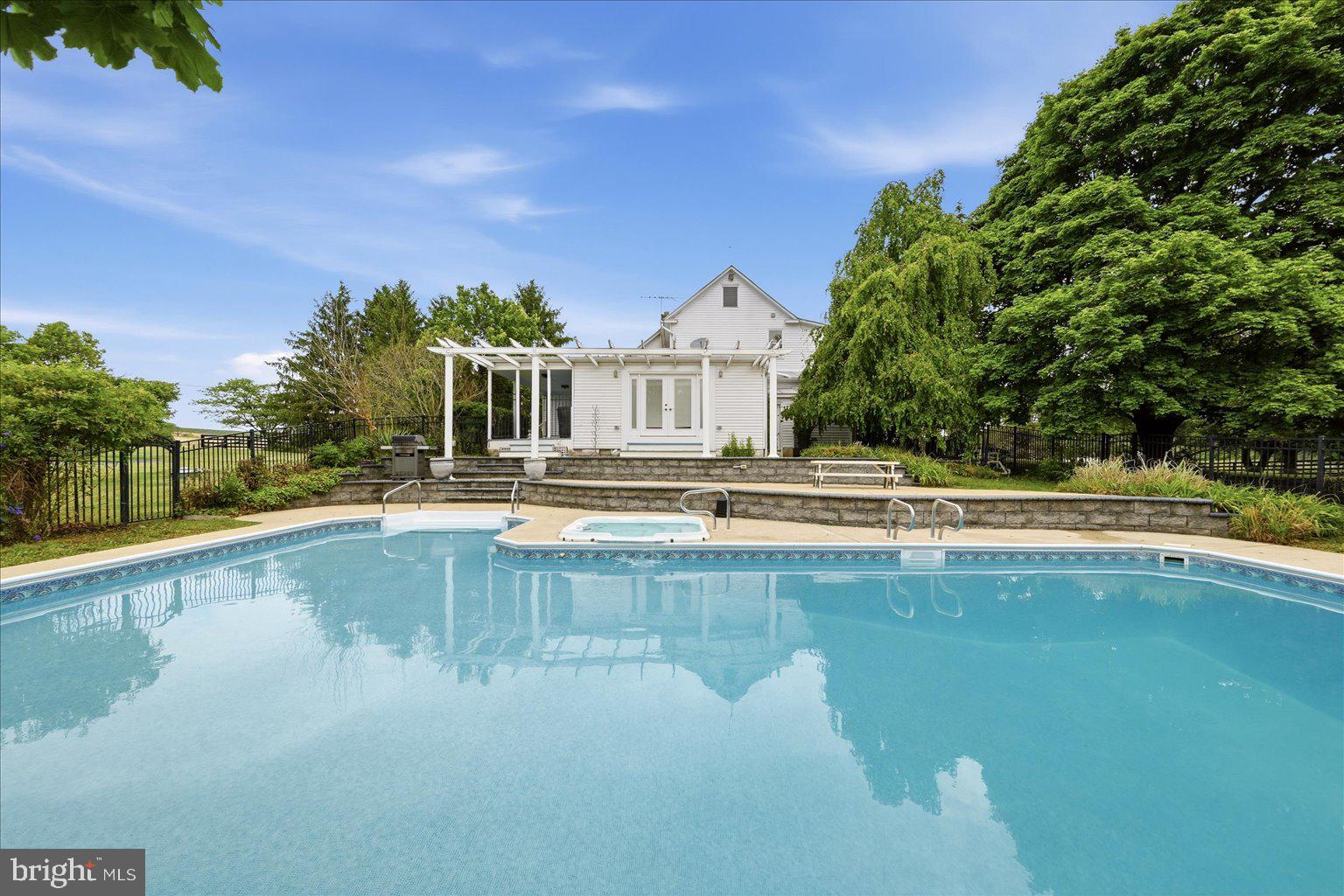 171 Laurel Grove Road Winchester, VA 22602 - Photo 4 of 81 a view of swimming pool with outdoor seating and house in the background