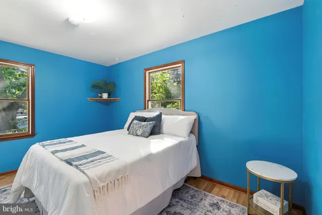 a bedroom with a bed and a potted plant