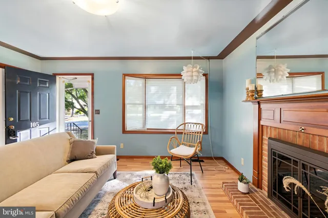 a living room with furniture a fireplace and a window