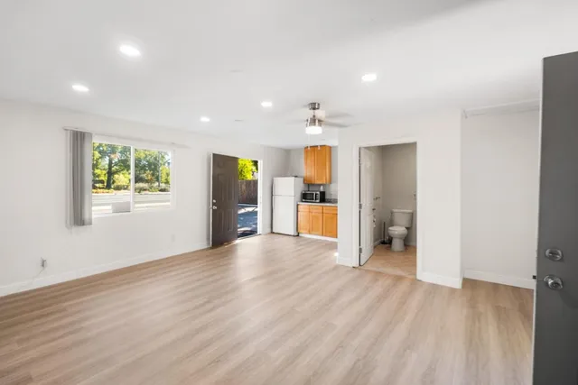 a view of an empty room with a kitchen