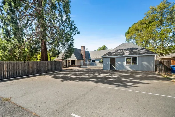 a backyard of a house with a tree