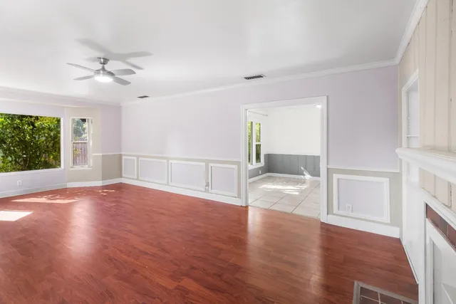 wooden floor in an empty room with a window