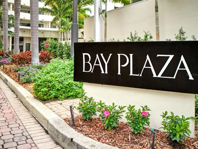 a dining room with furniture and a floor to ceiling window