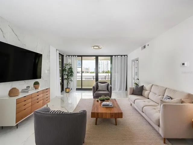 a view of a livingroom with furniture and an empty room